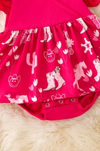 Fuschia dress with cowgirl boots and horse print on a fluffy white background