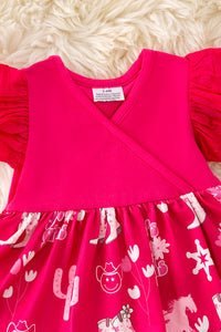 Fuschia dress with animal print on a fluffy white surface