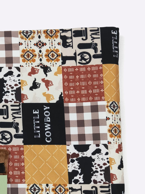Patchwork blanket with cowboy-themed patterns and text on a white background