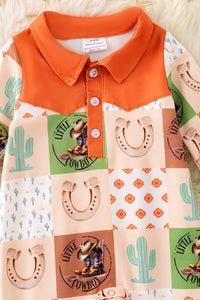 Baby's romper with orange collar and cowboy-themed patchwork design.