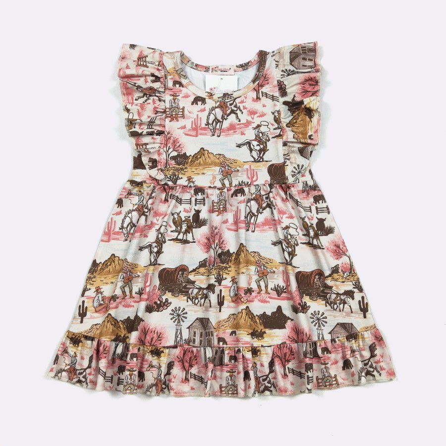 A sleeveless tiered dress for toddlers or girls, featuring a western-themed print with cowboys, mountains, cacti, and windmills in pink, brown, and black on a cream background.