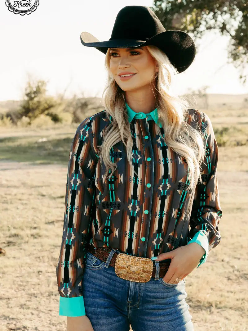 Adult woman wearing Rodeo Royalty Duo Red Dirt Road Top with turquoise accents, front view.