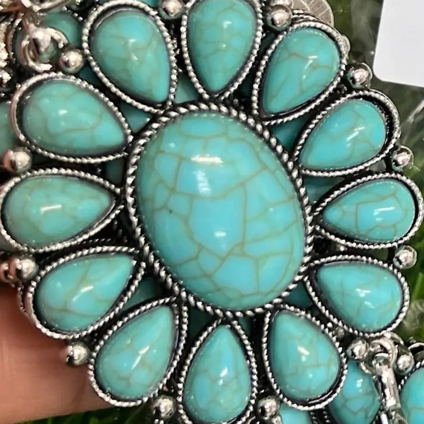 Close-up of turquoise floral concho design on Western girls’ aqua concho belt.