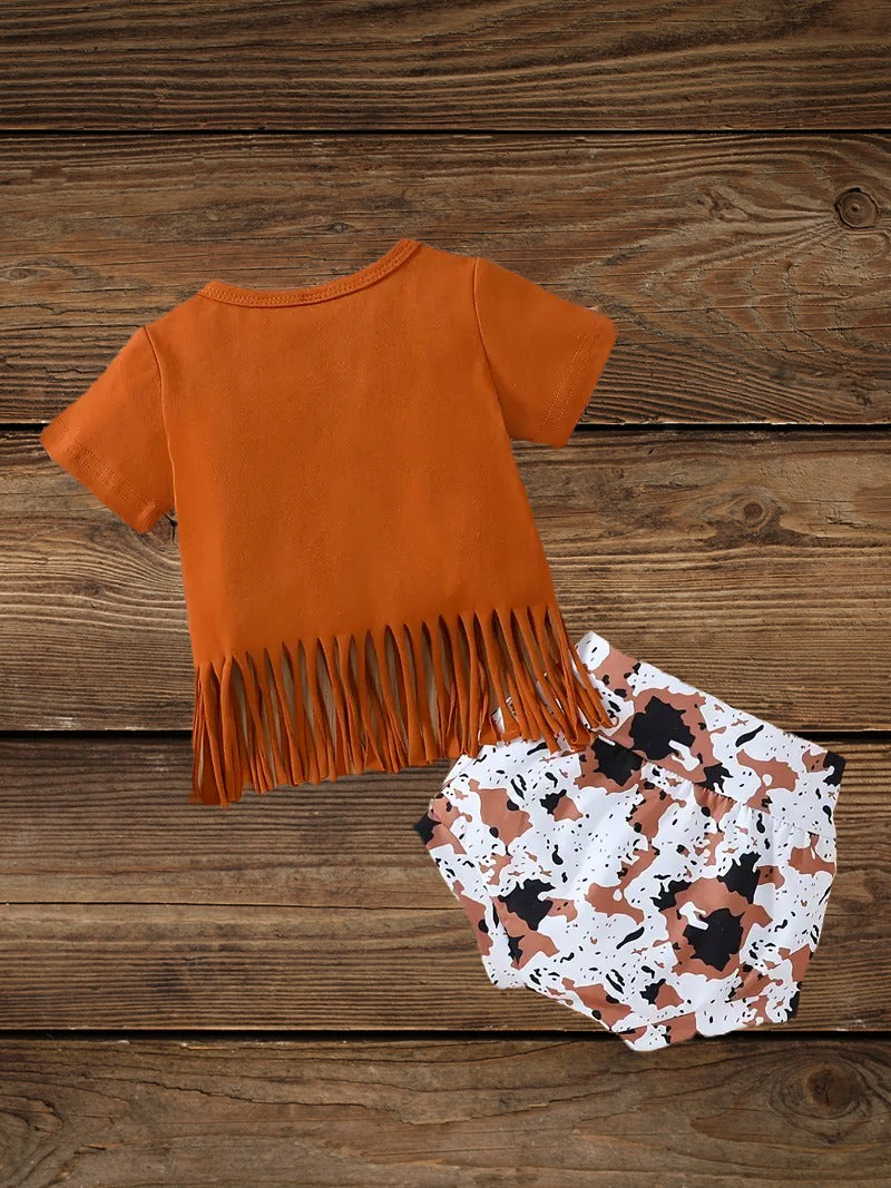 Back view of cow print baby girl shorts from the Wild Babe western-inspired baby set.