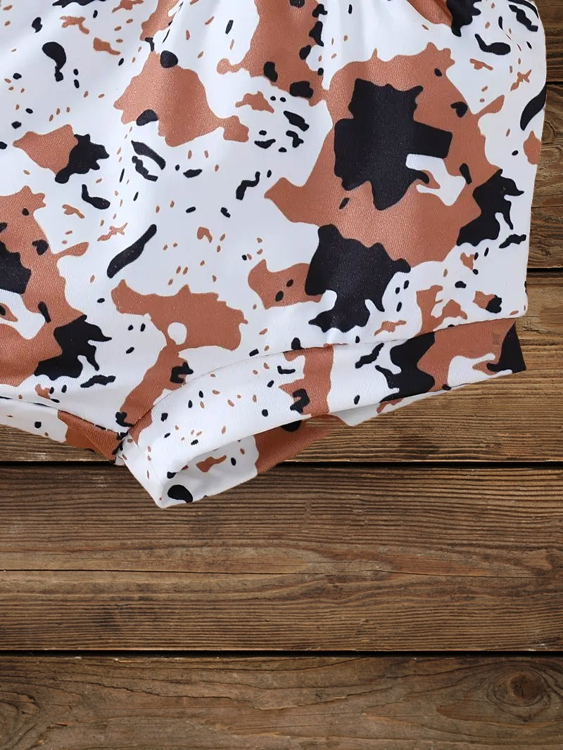 Back view of cow print baby girl shorts from the Wild Babe western-inspired baby set.