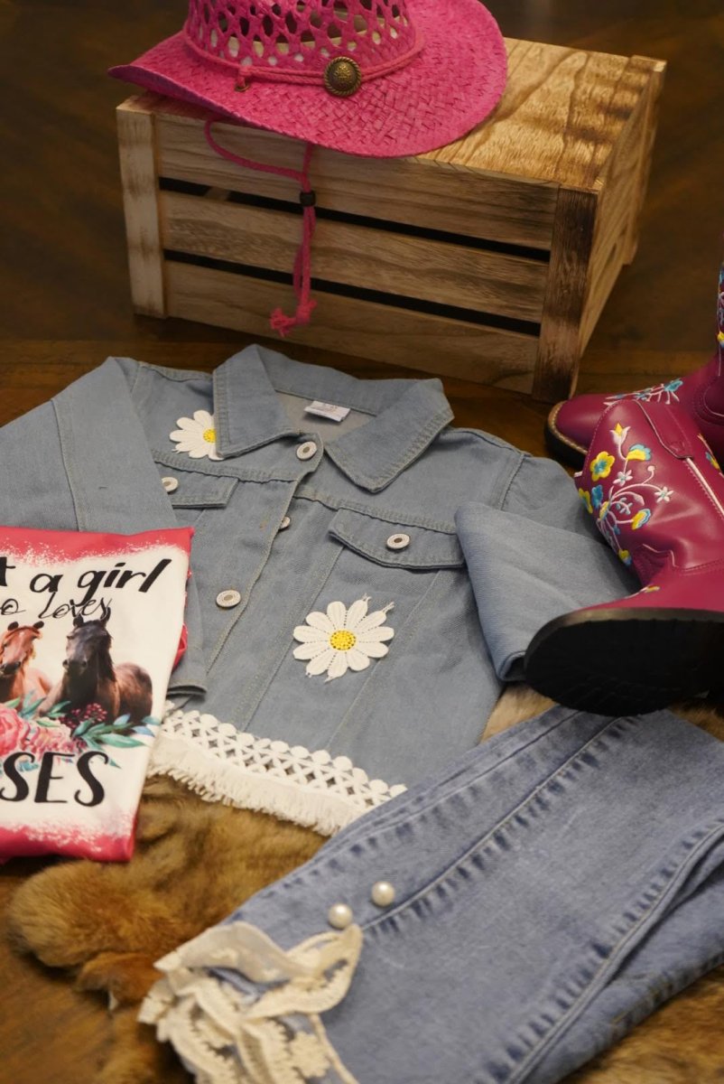 Toddler denim jacket styled with pink cowgirl hat, boots, jeans, and horse-themed book for a western look.