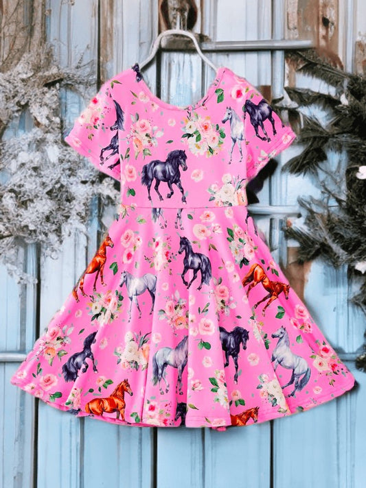 Pink equestrian print dress for girls with colorful pony graphics, short sleeves, and floral accents.
