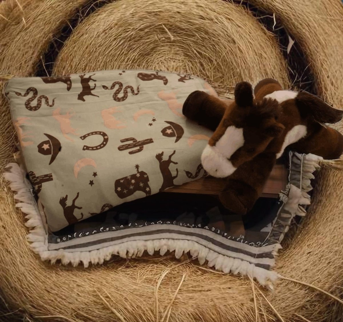 Giddyup baby blanket laid out with western accessories