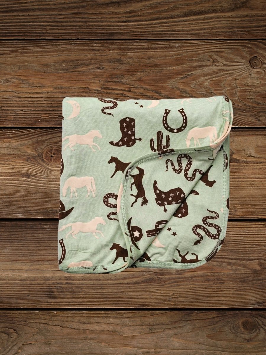 Folded giddyup bamboo baby blanket with western print