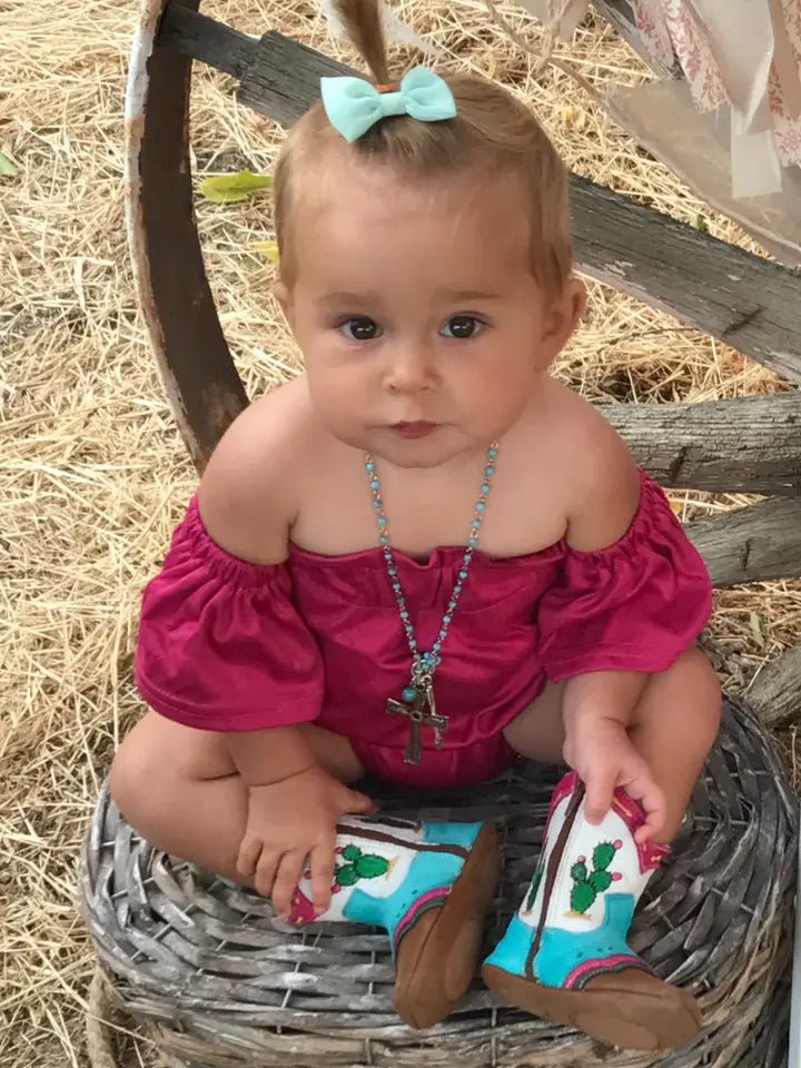 Little girl sitting in red dress with Pecos Cactus Boots