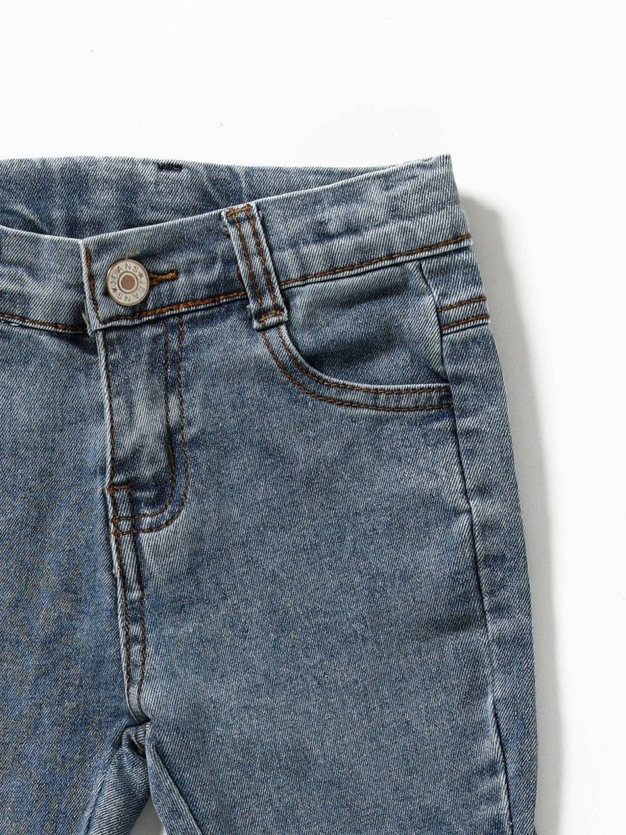 Close-up of blue denim jeans on a white background