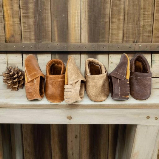 Leather newborn moccasins in Saddle, Latte, and Sable colors for baby cowboys and cowgirls