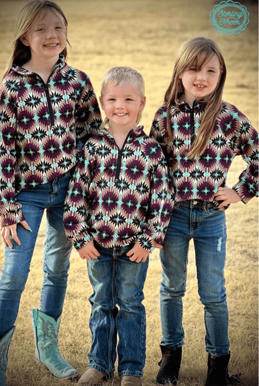Three kids wearing Mini Badlands Pullover with dark purple and turquoise Aztec design, perfect for adventure-ready outfits and chilly days on the ranch.
