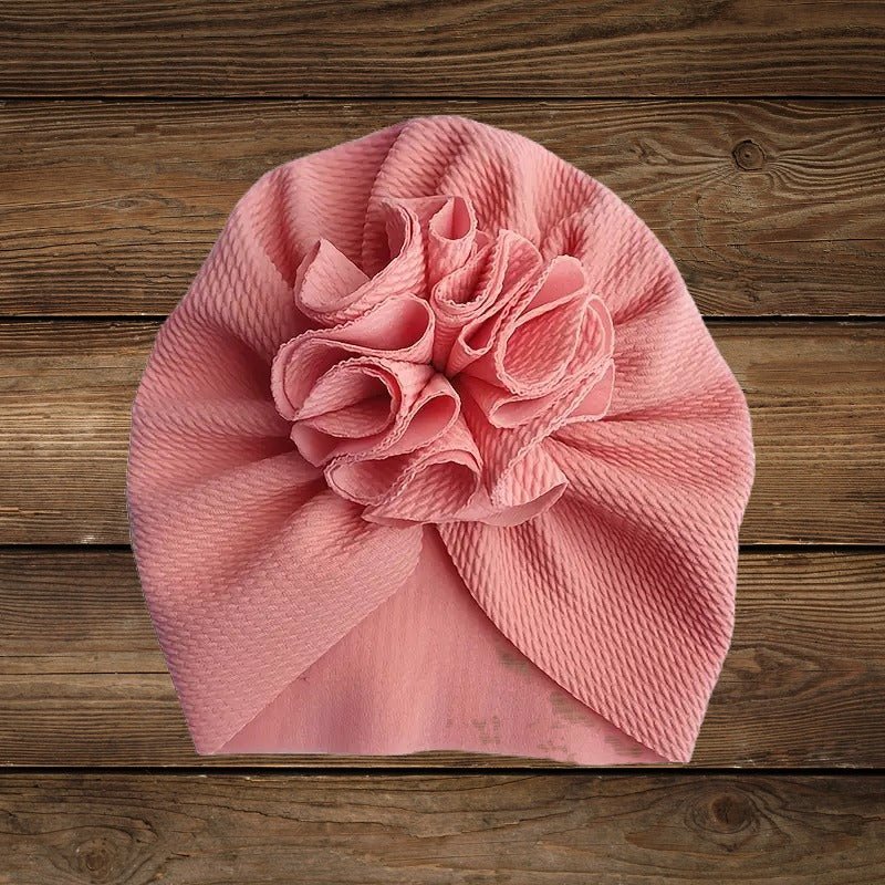 Light pink turban hat with large rosette front knot