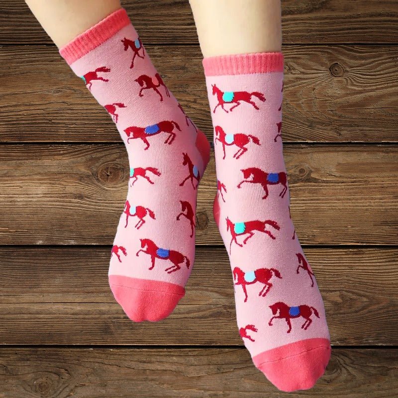 Pink western horse socks on child’s legs