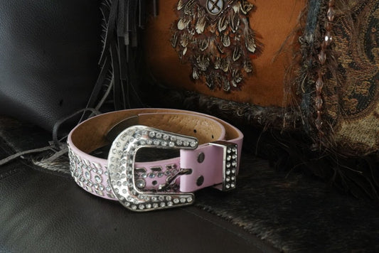 Pink rhinestone cowgirl belt with sparkling buckle on Western leather background, perfect cowgirl kids' belt.