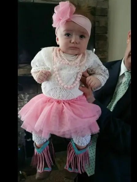 Baby girl in fluffy tutu and fringe western boots