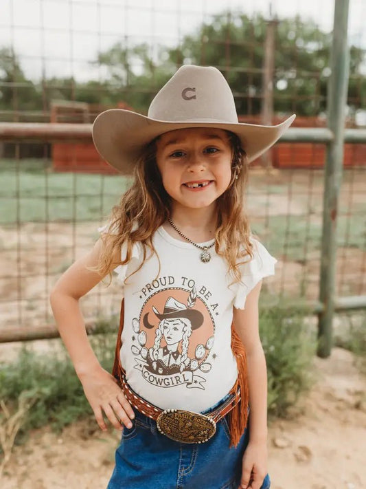 Girl wearing Proud Cowgirl Spirit fringe tee with hat