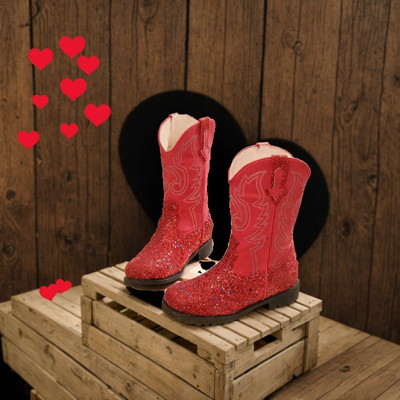 Red glitter square toe cowgirl boots on wooden crates with hearts