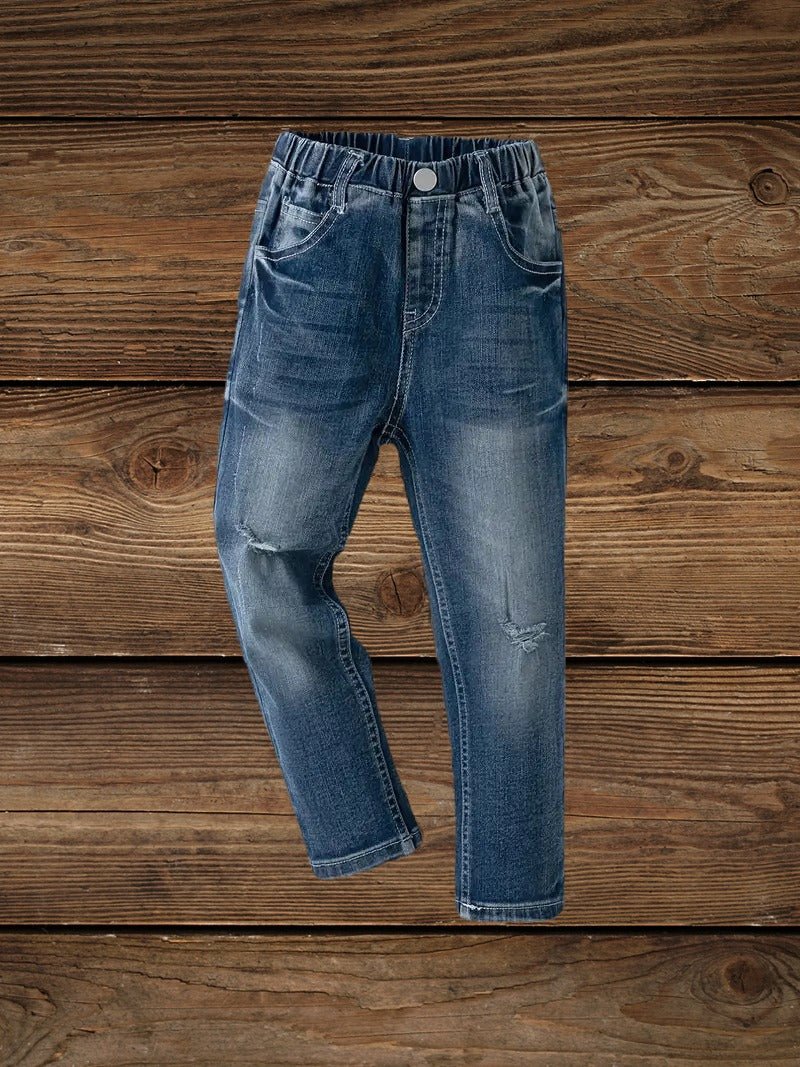Boys' high-stretch denim ripped jeans front view on wooden.background