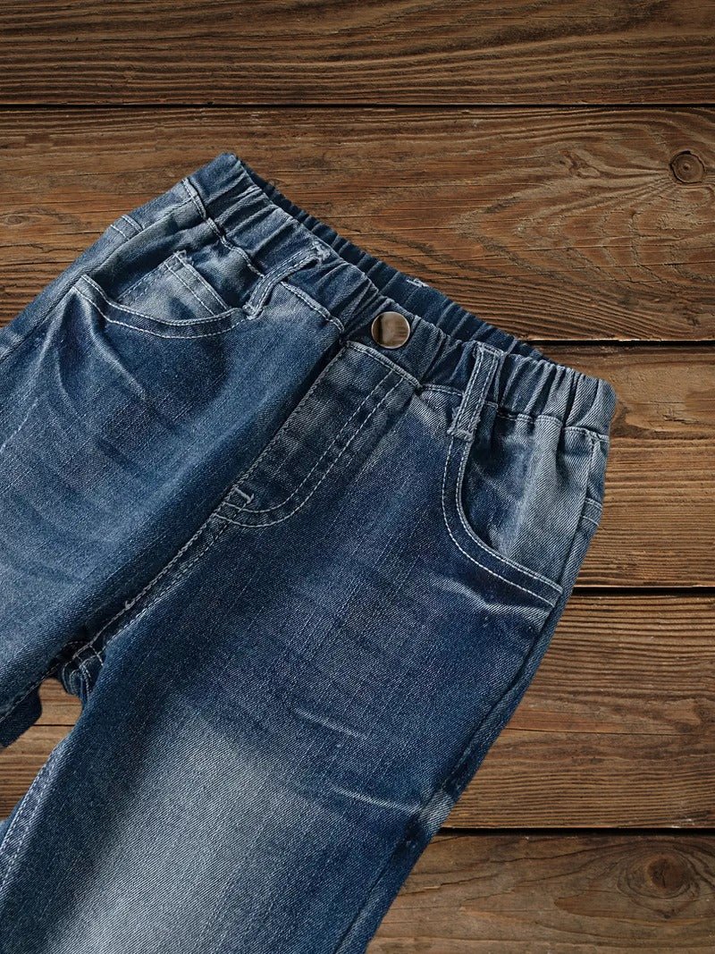 Top detail of boys' high-stretch denim ripped jeans with front pockets and waistband.