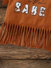 Detail of Wild Babe tassel top baby outfit, western style for adventurous little girls.