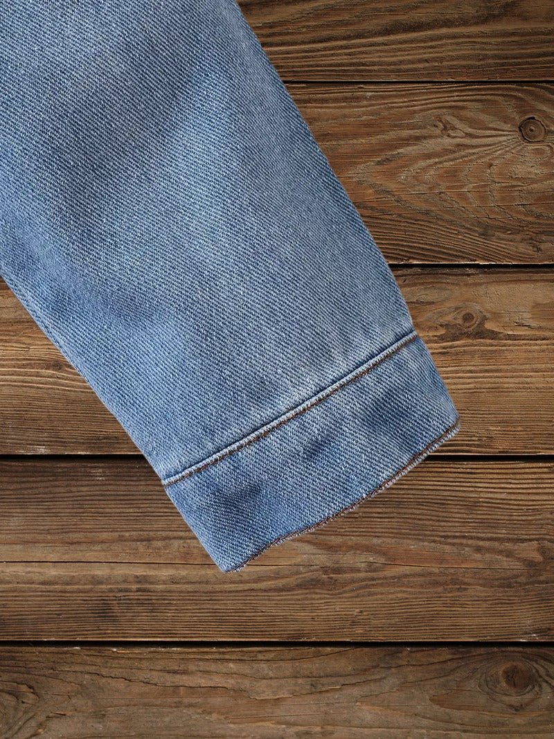Sleeve detail of toddler western denim jacket showing stitching and fabric texture.