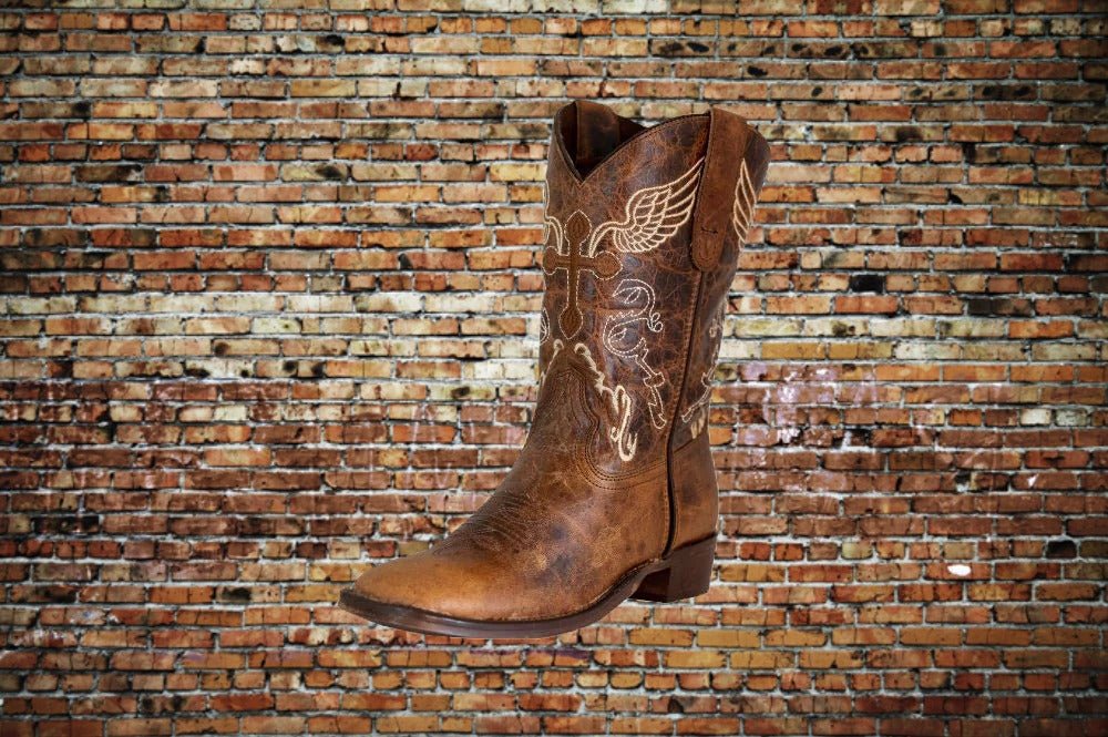 Angled front side view of Tuffrider kids' Western boot with embroidered cross and wing.