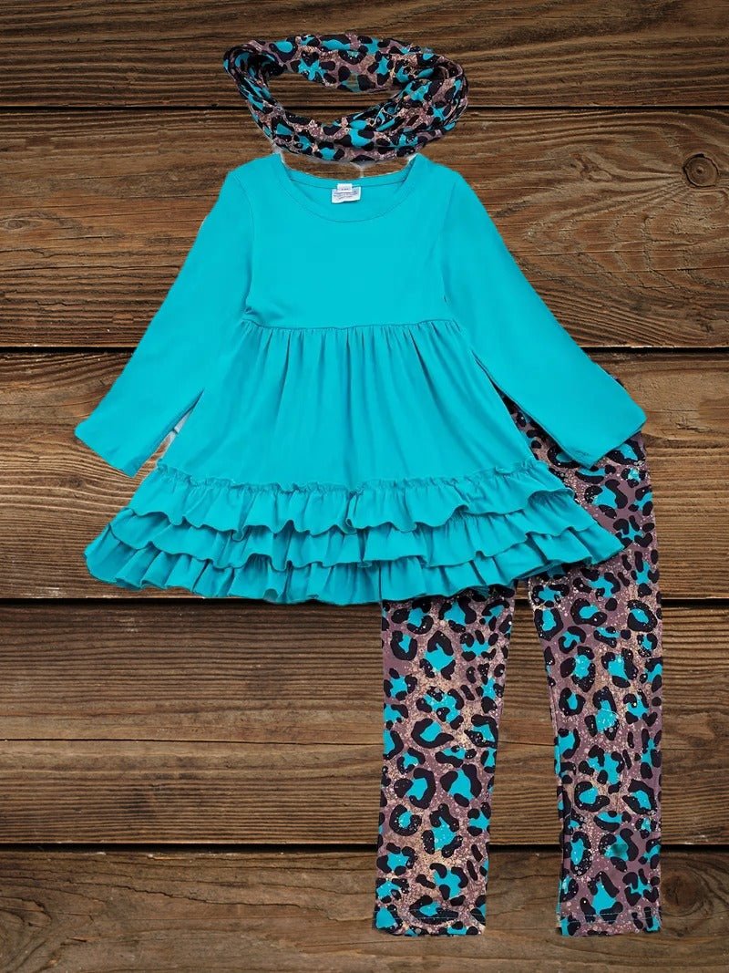 Turquoise cow print top with leopard print pants