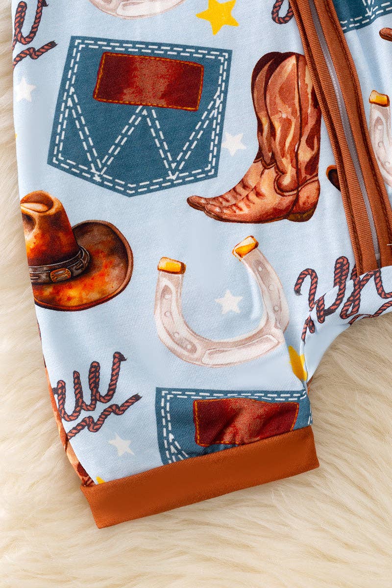 Bottom detail of Western baby romper with cowboy boots and hat print.