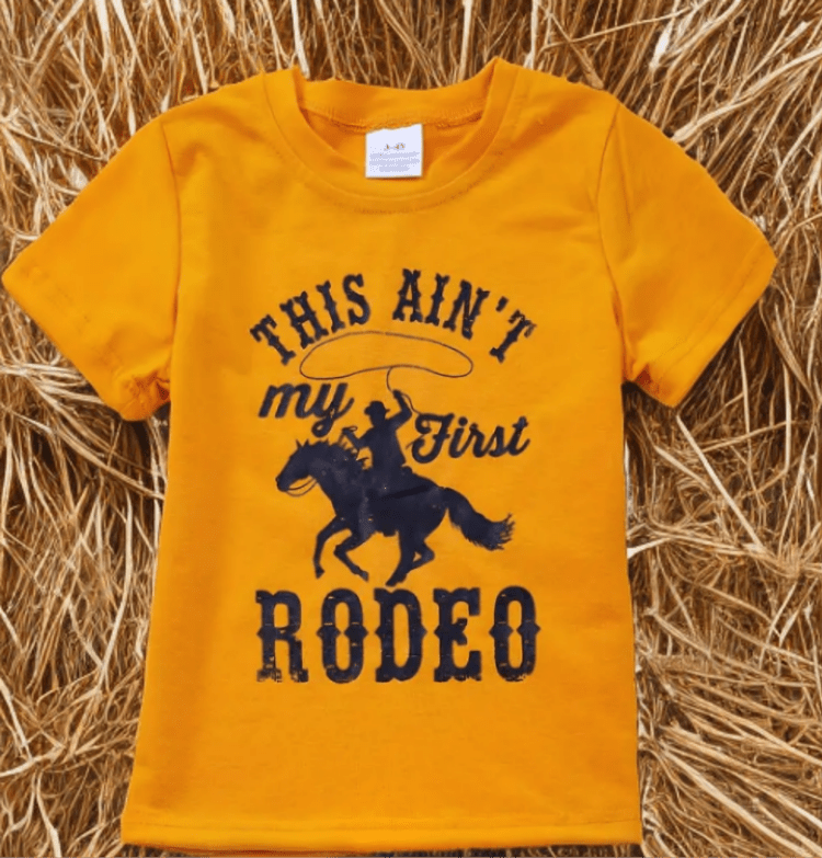 Kids yellow cowboy t-shirt with "This Ain’t My First Rodeo" design and horse graphic