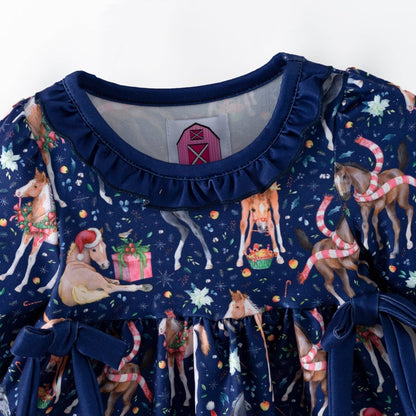 Ruffled navy neckline and festive horse print on the Christmas baby top.