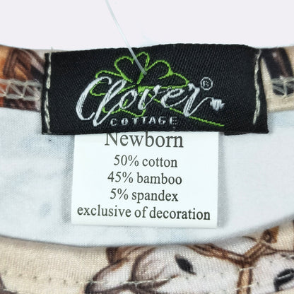 Close-up of a garment's interior neck label showing the brand Clover Cottage and a white care tag with fabric composition details.