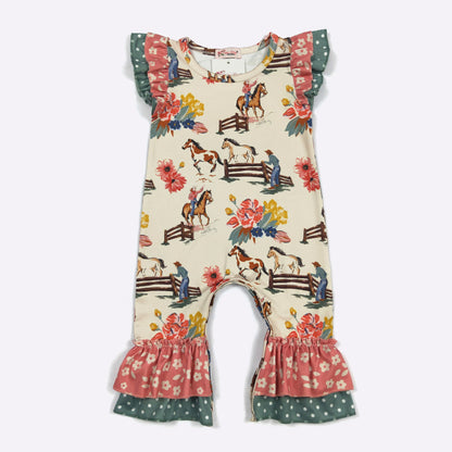 A baby girl's one-piece romper with a cream background and an equestrian theme print. The romper features ruffled sleeves and leg hems, with a pattern of horses, fences, and flowers in pink, green, yellow, and blue.