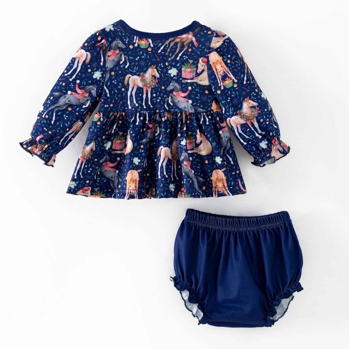 Back view of the navy Christmas horse print baby top with coordinating solid navy bloomers.