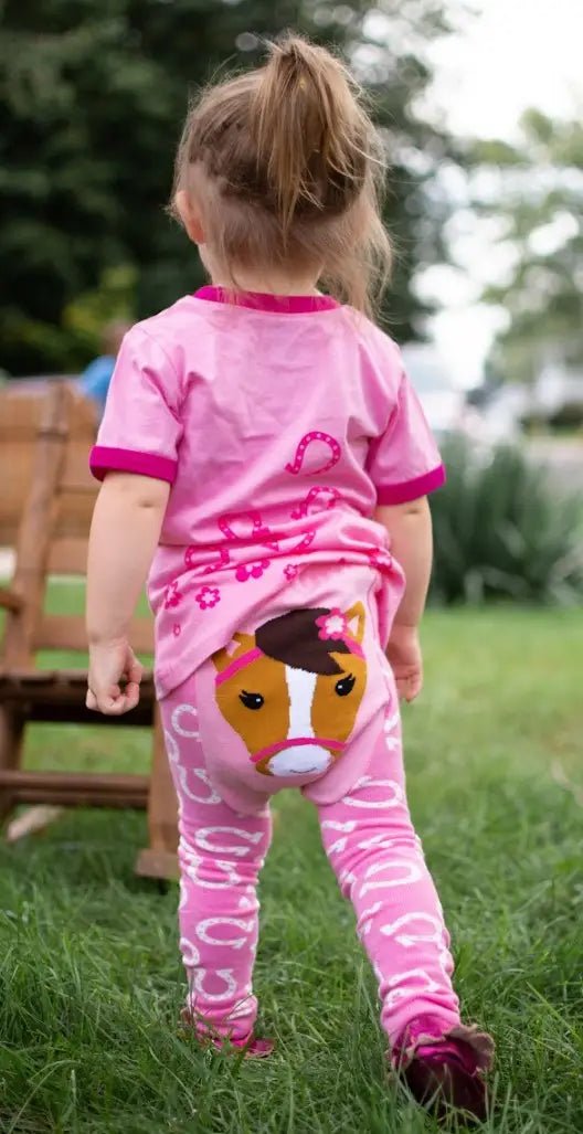 Child wearing pink horse leggings