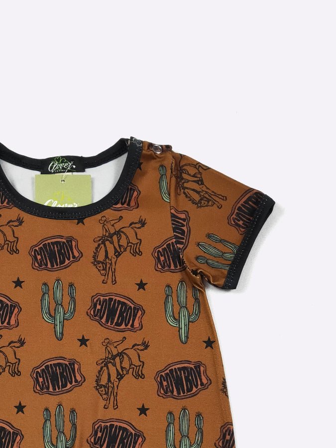 Baby romper with cowboy and cactus pattern on a white background