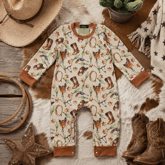 Baby romper with cowboy pattern on a wooden surface with rustic decor