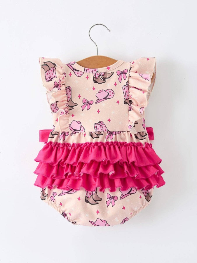 Pink and beige back of cowgirl romper with ruffles on a hanger against a white background
