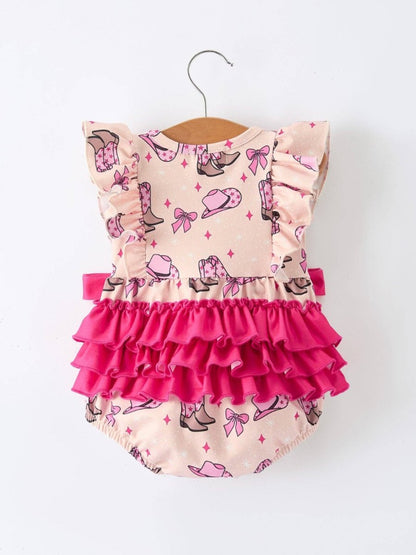 Pink and beige back of cowgirl romper with ruffles on a hanger against a white background