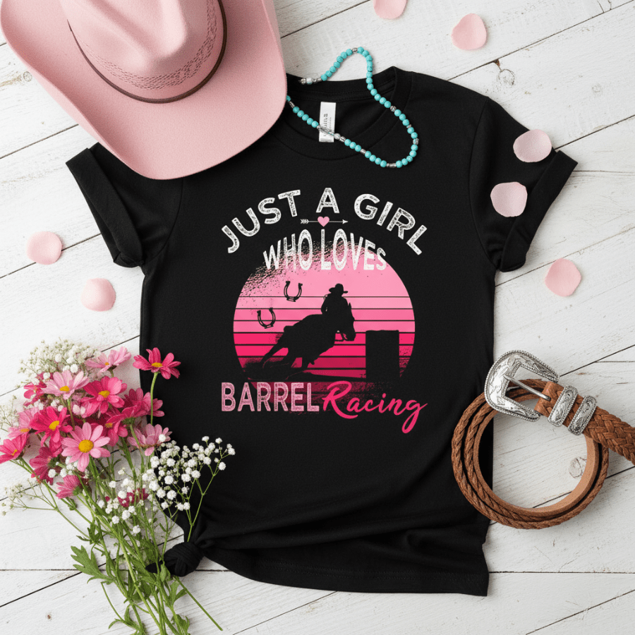 Black t-shirt with barrel racing design and accessories on a wooden surface