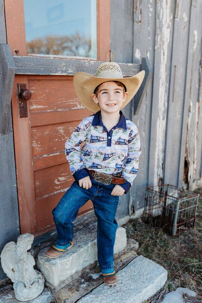 Child wearing a cowboy hat and shirt standing on stone steps outdoors.