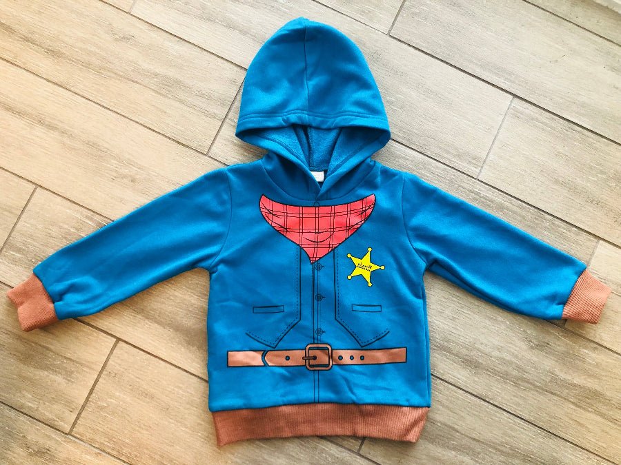 Blue children's hoodie with Sheriff design on a wooden floor