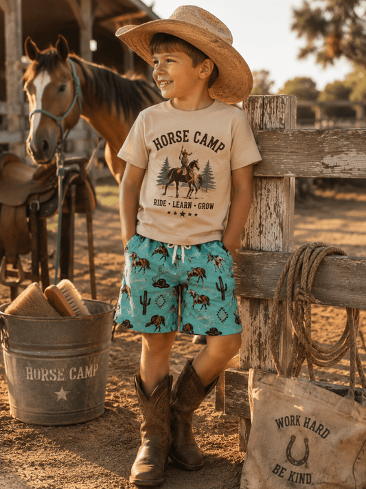 Little cowboy in beach shorts