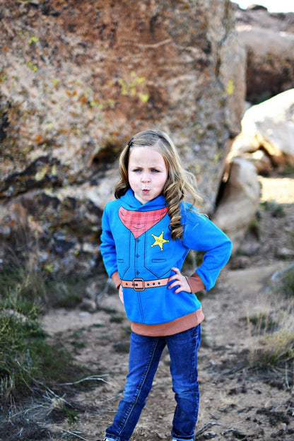 Child in a sheriff hoodie in a rocky outdoor setting