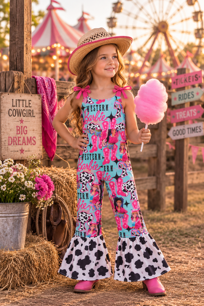 A young girl stands in a rustic fair or carnival setting wearing a bright pink and turquoise Western Barbie-themed jumpsuit with cow-print flared hems, a straw hat, and holding a pink cotton candy. The background features wooden signs, hay bales, and a blurred ferris wheel.