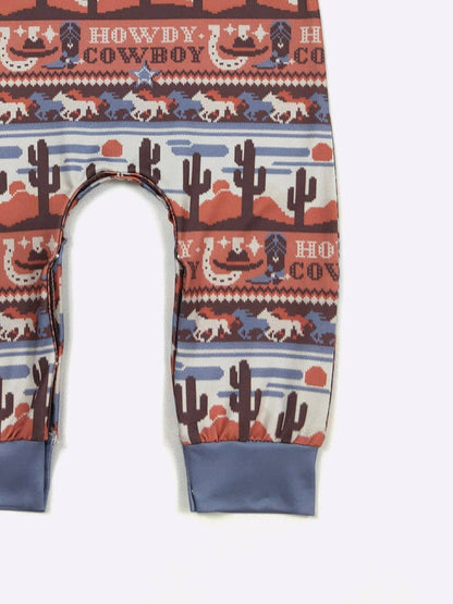 Romper with a cowboy-themed pattern on a white background