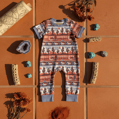 Howdy Cowboy baby romper desert flat lay with geode turquoise stones and dried cactus - western infant clothes