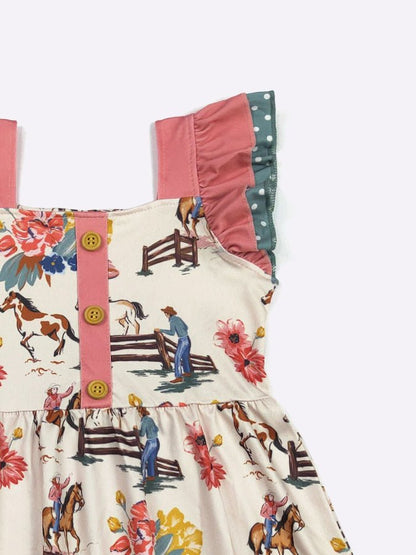 Children's dress with horse and cowboy print on a white background