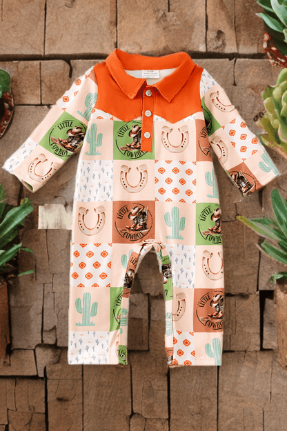 Children's outfit with cowboy-themed pattern on a wooden background